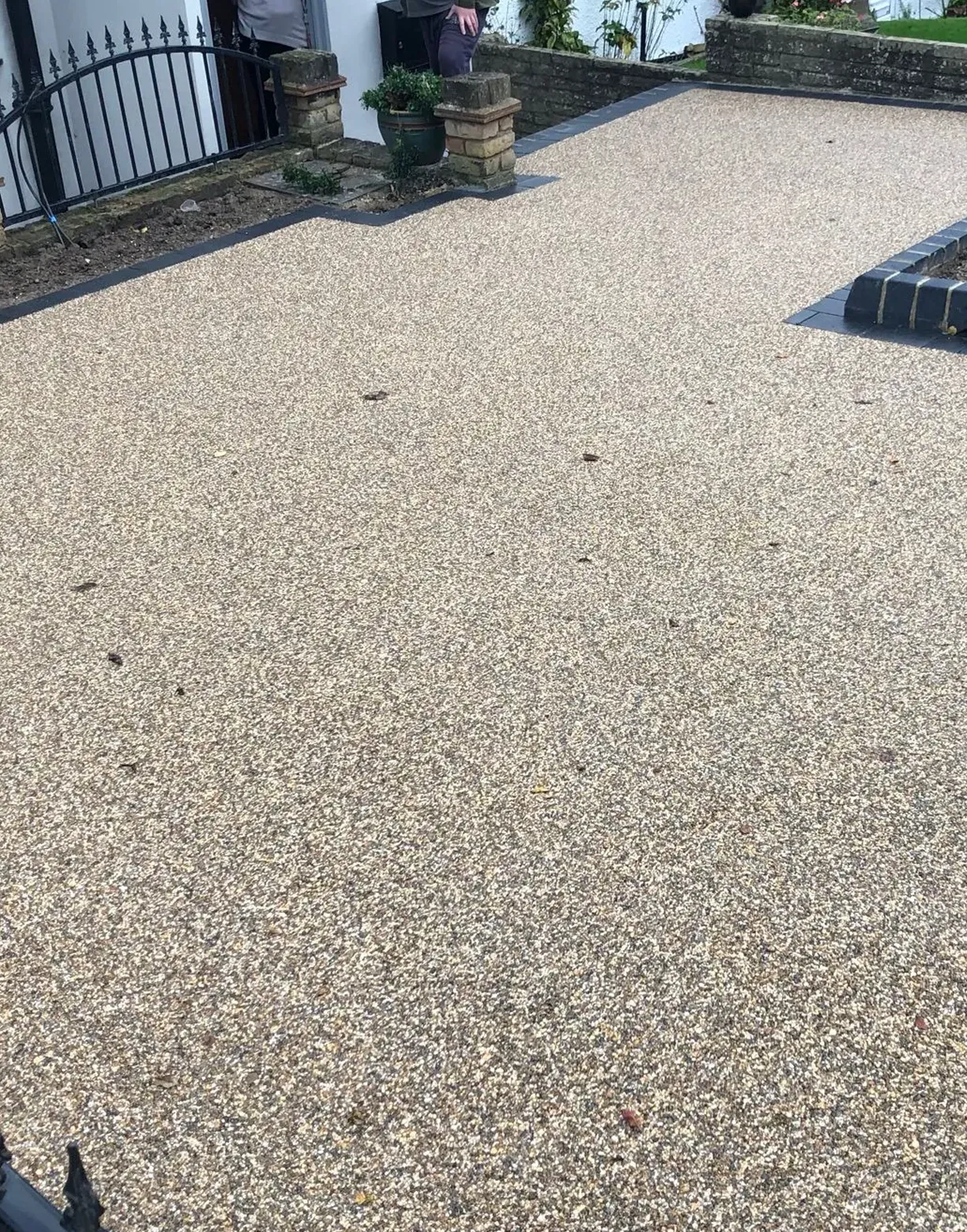 a black fire hydrant sitting in the middle of a driveway