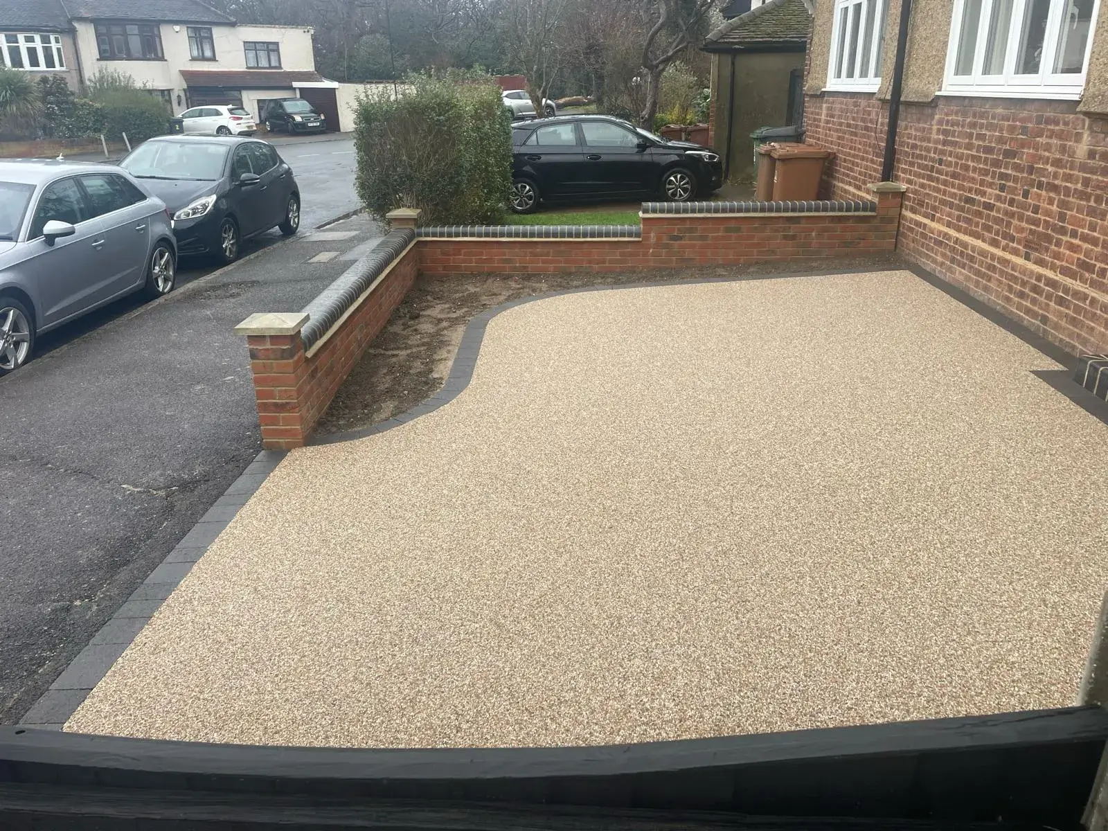 a car parked in a driveway next to a house