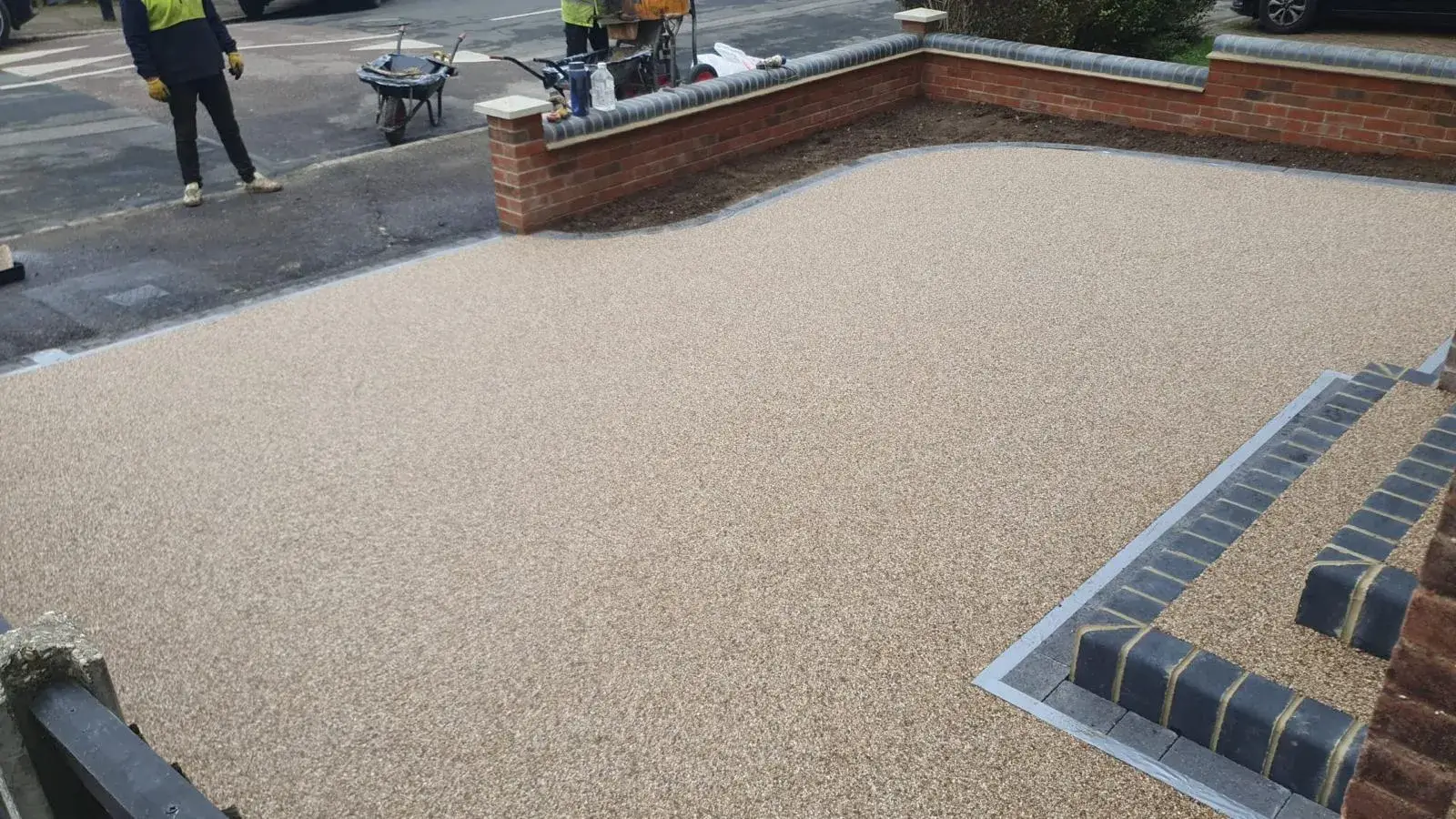 a man in a yellow vest is standing on a sidewalk