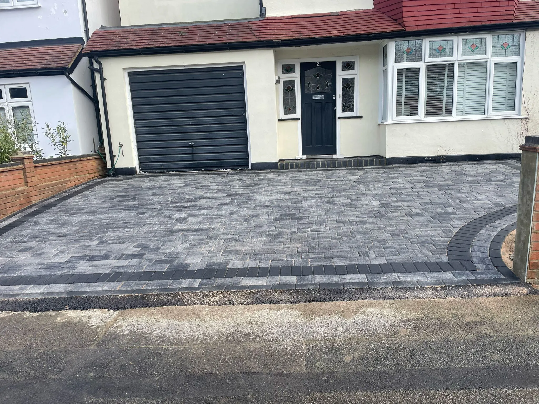 a house with a driveway made of bricks