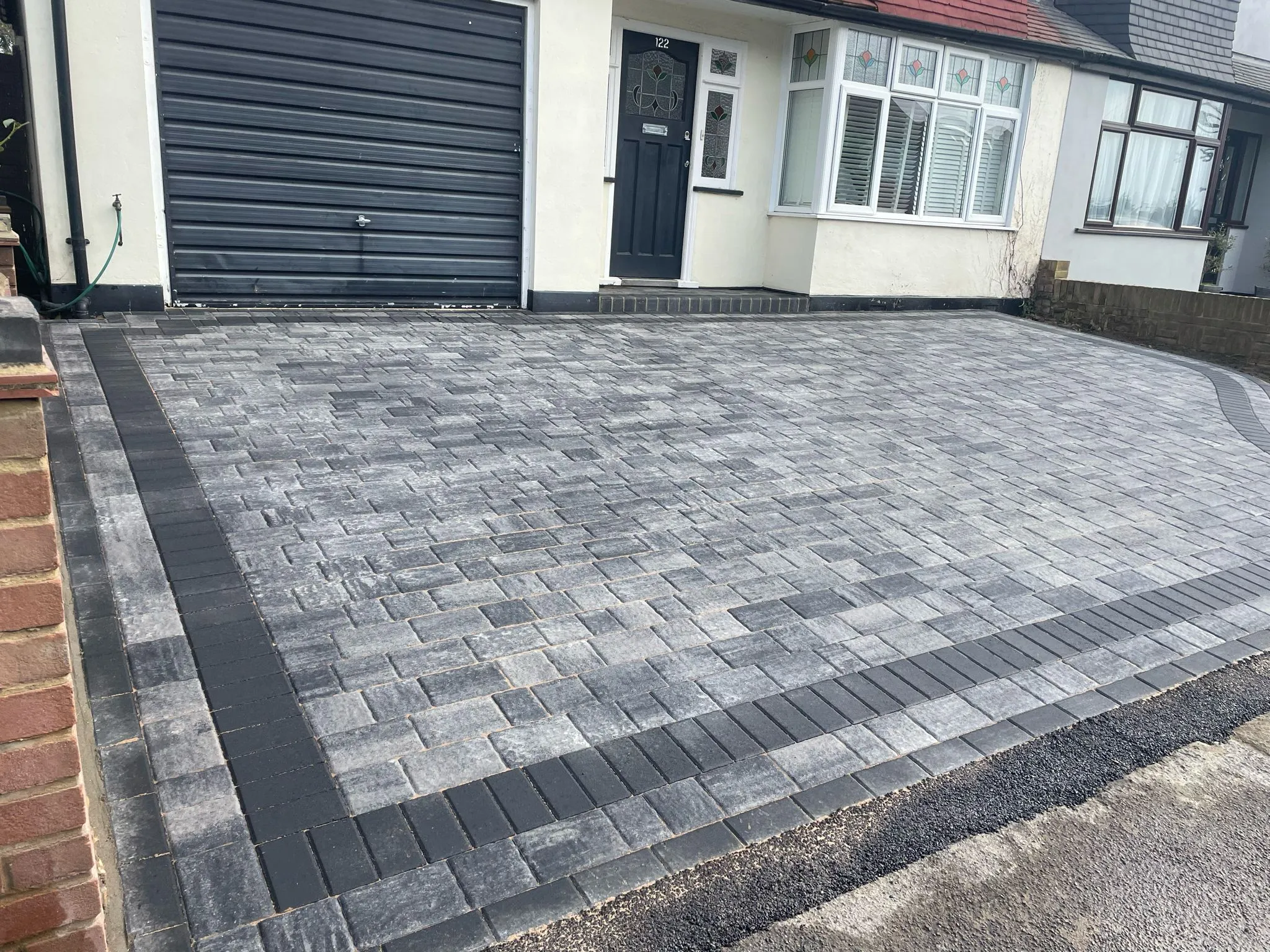 a house with a driveway made of bricks