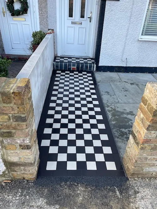 a black and white checkered floor in front of a house