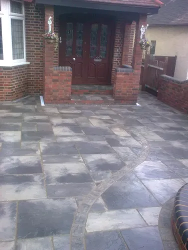 a brick house with a large stone patio