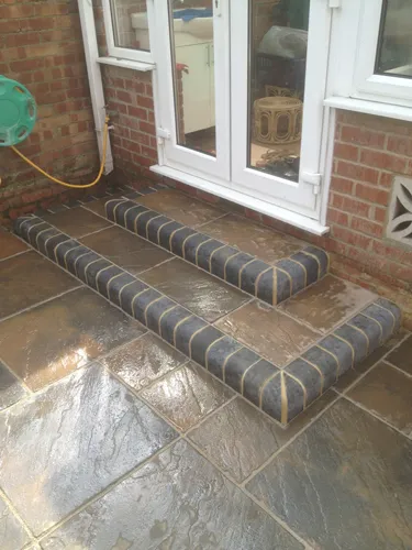 a set of steps sitting in front of a brick building