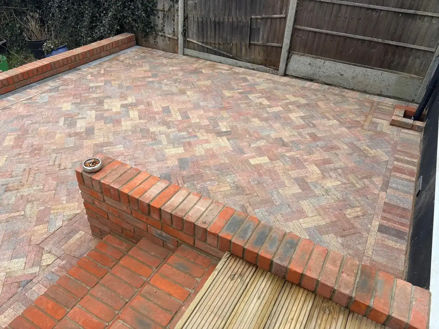 A brick patio with steps leading up to it.