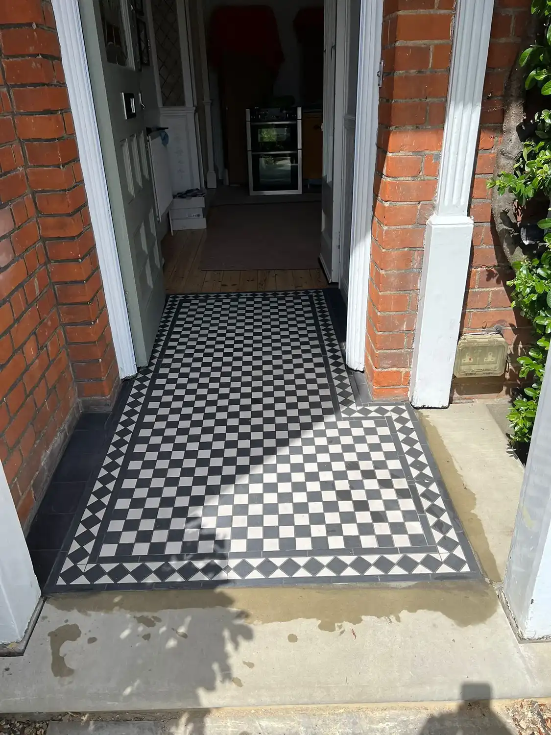 A black and white checkered floor in front of a door.