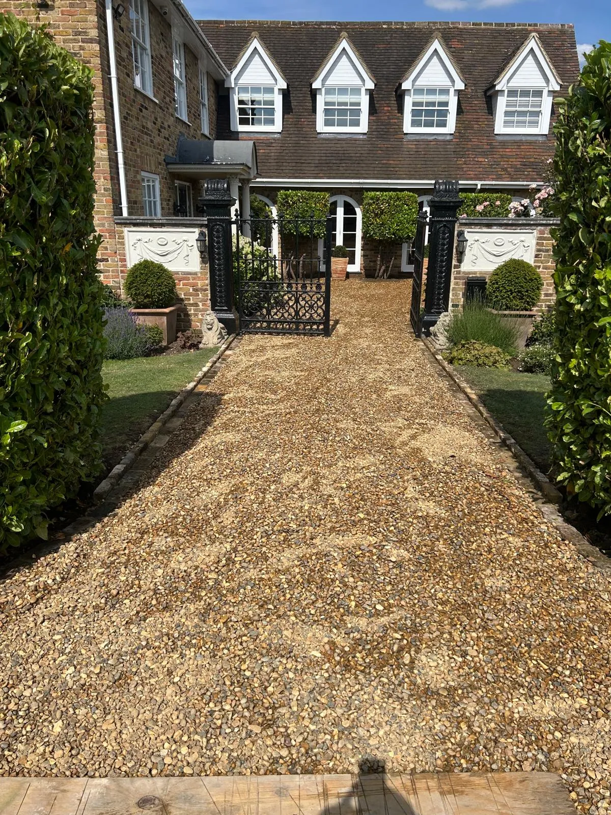 A large house with a driveway and a gate.