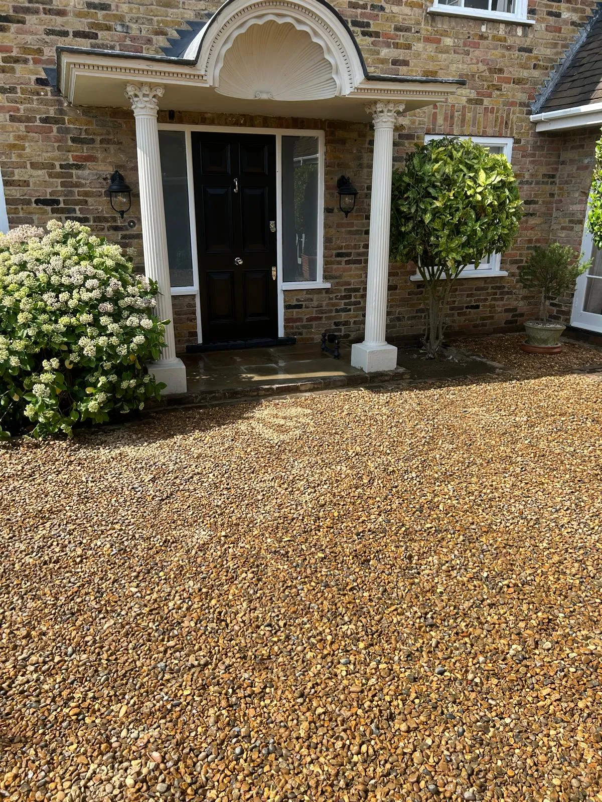 A house with a black front door and white trim.