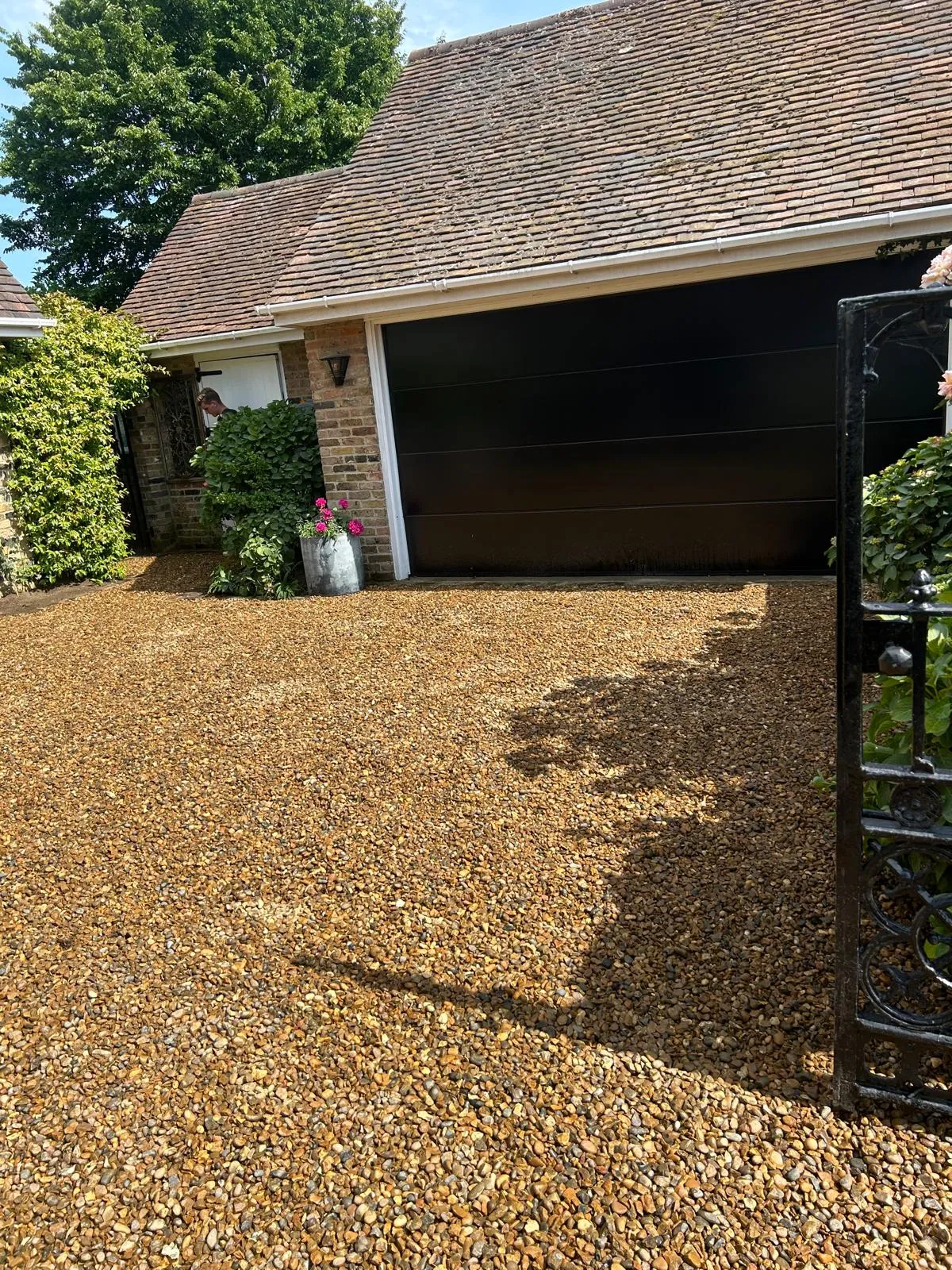 A driveway with gravel and a garage door.