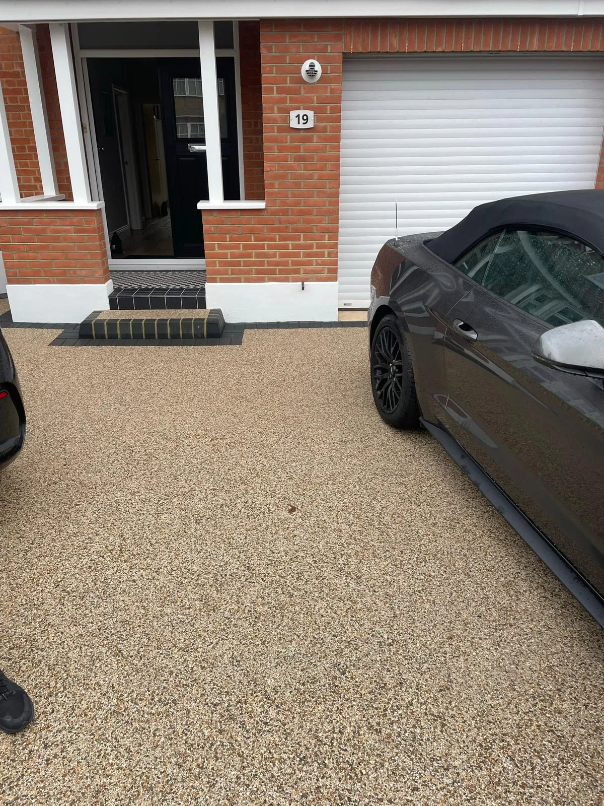 two cars parked in front of a house