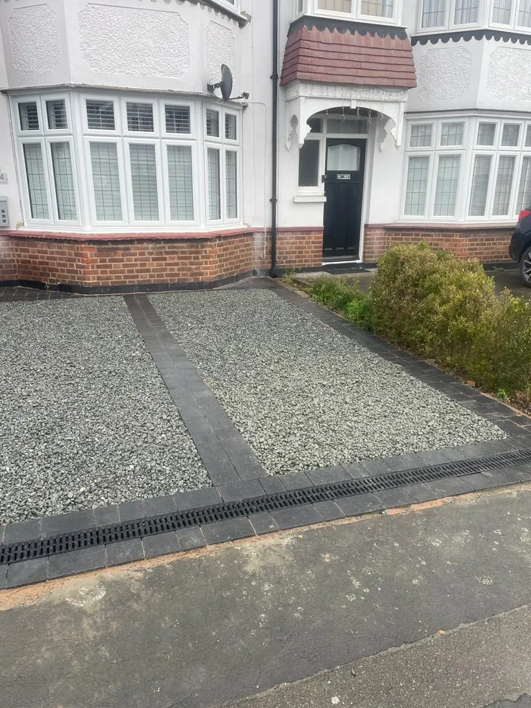 a house with a gravel driveway in front of it